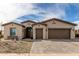 Charming single-story home with a three car garage, desert landscaping, and brick accents at 2306 N Floyd Dr, Mesa, AZ 85215