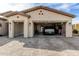 Spacious three car garage with brick trim, an electric vehicle, and a home gym at 2306 N Floyd Dr, Mesa, AZ 85215