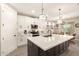 Modern kitchen with a large island, stainless steel appliances, pendant lights, and white cabinetry at 2306 N Floyd Dr, Mesa, AZ 85215