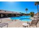 Community pool featuring a rock waterfall, a spa, and desert landscaping at 2306 N Floyd Dr, Mesa, AZ 85215