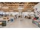 Large workshop area with exposed wood ceiling, workbenches, and tool storage at 2306 N Floyd Dr, Mesa, AZ 85215