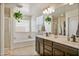 Main bathroom with double vanity, soaking tub, and shower at 2404 E Gillcrest Rd, Gilbert, AZ 85298