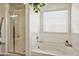 Bathroom with shower and bathtub,plant, and window at 2404 E Gillcrest Rd, Gilbert, AZ 85298