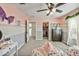 Pink and grey bedroom with two beds and a closet at 2404 E Gillcrest Rd, Gilbert, AZ 85298