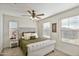 Bedroom with plush bed, window, and ceiling fan at 2404 E Gillcrest Rd, Gilbert, AZ 85298