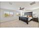 Main bedroom with large bed, ceiling fan, and ample natural light at 2404 E Gillcrest Rd, Gilbert, AZ 85298