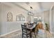 Dining room with wood table, four chairs, and a modern light fixture at 2404 E Gillcrest Rd, Gilbert, AZ 85298