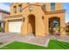 Front entrance with arched entryway, stone walkway, and landscaping at 2404 E Gillcrest Rd, Gilbert, AZ 85298
