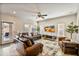Gathering room with leather couches, large TV, and sliding door to backyard at 2404 E Gillcrest Rd, Gilbert, AZ 85298