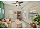 Living room with brown leather sofa, large TV, and wood-look floors at 2404 E Gillcrest Rd, Gilbert, AZ 85298