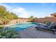Inviting pool with lounge chairs, water feature, and surrounding landscaping at 2404 E Gillcrest Rd, Gilbert, AZ 85298