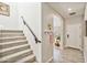 Gray carpeted staircase with dark wood railing and access to the second floor at 2404 E Gillcrest Rd, Gilbert, AZ 85298