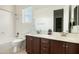 Bright bathroom features double sinks, modern fixtures, and a tub-shower combination at 26921 N 100Th Ave, Peoria, AZ 85383