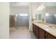 Elegant bathroom featuring double sinks, ample counter space, and a glass-enclosed shower at 26921 N 100Th Ave, Peoria, AZ 85383