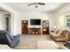 Bright living room with light hardwood floors, ceiling fan and comfortable seating at 26921 N 100Th Ave, Peoria, AZ 85383