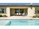 Charming covered patio with comfortable seating area, ideal for relaxing and entertaining by the pool at 26921 N 100Th Ave, Peoria, AZ 85383