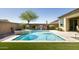 Backyard oasis features a refreshing pool, outdoor kitchen, and lush greenery for luxurious outdoor living at 26921 N 100Th Ave, Peoria, AZ 85383