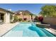 Sparkling pool with water feature, surrounded by desert landscaping offering a serene backyard retreat at 26921 N 100Th Ave, Peoria, AZ 85383