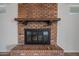 Close-up of a brick fireplace with a wood mantel at 2918 E Laurel Ln, Phoenix, AZ 85028