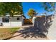 View of backyard with grassy area, gate, and concrete driveway at 321 W Palo Verde St, Gilbert, AZ 85233
