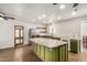 Updated kitchen features green cabinetry, an island, and a stylish backsplash at 321 W Palo Verde St, Gilbert, AZ 85233