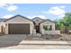Charming single-story home with a well-maintained front yard and a two-car garage at 3218 N Lafayette Dr, Florence, AZ 85132