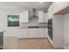 Modern kitchen with white cabinets, stainless steel appliances, and a large window at 3218 N Lafayette Dr, Florence, AZ 85132