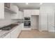 Bright kitchen featuring granite countertops, white cabinetry, and a stainless steel range at 3218 N Lafayette Dr, Florence, AZ 85132