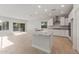 Spacious living area with kitchen island and sliding glass door to the backyard at 3218 N Lafayette Dr, Florence, AZ 85132