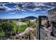 Elevated view of a golf course with sprinklers, desert plants, and mountains from a private balcony at 37200 N Cave Creek Rd # 2127, Scottsdale, AZ 85262