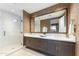 Modern bathroom featuring a dual vanity, large mirror, and walk-in shower with beautiful tile and stone accents at 37200 N Cave Creek Rd # 2127, Scottsdale, AZ 85262