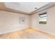 Bright, empty room with hardwood floors and a sunlit window showing landscaping at 37200 N Cave Creek Rd # 2127, Scottsdale, AZ 85262