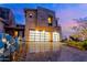 Contemporary home with a stone facade, three-car garage, and desert landscaping at 37200 N Cave Creek Rd # 2127, Scottsdale, AZ 85262