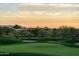 Scenic view of a golf course at sunset, featuring desert vegetation, mountains, and manicured greens at 37200 N Cave Creek Rd # 2127, Scottsdale, AZ 85262