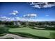 Picturesque view of a well-maintained golf course with a clear blue sky and fluffy white clouds at 37200 N Cave Creek Rd # 2127, Scottsdale, AZ 85262