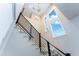Open staircase featuring wood steps, black metal railing, and natural light from windows above at 37200 N Cave Creek Rd # 2127, Scottsdale, AZ 85262