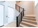 Staircase featuring wood steps, black metal railing, and neutral colored walls at 37200 N Cave Creek Rd # 2127, Scottsdale, AZ 85262