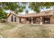 Back of home with covered patio and spa, desert landscaping, and bright blue skies at 532 S Lagoon Dr, Gilbert, AZ 85233