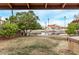 View of a canal from the backyard with a lush green lawn and mature trees at 532 S Lagoon Dr, Gilbert, AZ 85233