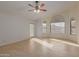 Bright and airy bedroom featuring tile floors, a ceiling fan, and large windows with views of the backyard at 532 S Lagoon Dr, Gilbert, AZ 85233