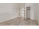 Bedroom featuring wood-look flooring, closet, and view to living room at 532 S Lagoon Dr, Gilbert, AZ 85233