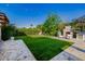 Landscaped backyard with artificial turf and firepit at 5430 E Calle Redonda --, Phoenix, AZ 85018