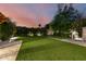 Landscaped backyard featuring a grassy lawn and brick patio at 5430 E Calle Redonda --, Phoenix, AZ 85018