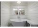 Freestanding soaking tub with shiplap walls and natural light at 5430 E Calle Redonda --, Phoenix, AZ 85018