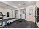 Home gym with a treadmill, weights, and mirrored walls at 5430 E Calle Redonda --, Phoenix, AZ 85018