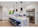 Modern kitchen boasts white cabinets, marble countertops, and a large island at 5430 E Calle Redonda --, Phoenix, AZ 85018