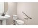 Clean bathroom with pedestal sink, toilet and grab bars at 5575 W Cinder Brook Way, Florence, AZ 85132