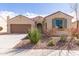 One-story house featuring a two-car garage and drought-tolerant landscaping at 5575 W Cinder Brook Way, Florence, AZ 85132