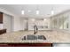 Kitchen island with double sink and granite countertop at 5575 W Cinder Brook Way, Florence, AZ 85132