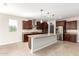 Spacious kitchen featuring dark wood cabinets and a large island at 5575 W Cinder Brook Way, Florence, AZ 85132